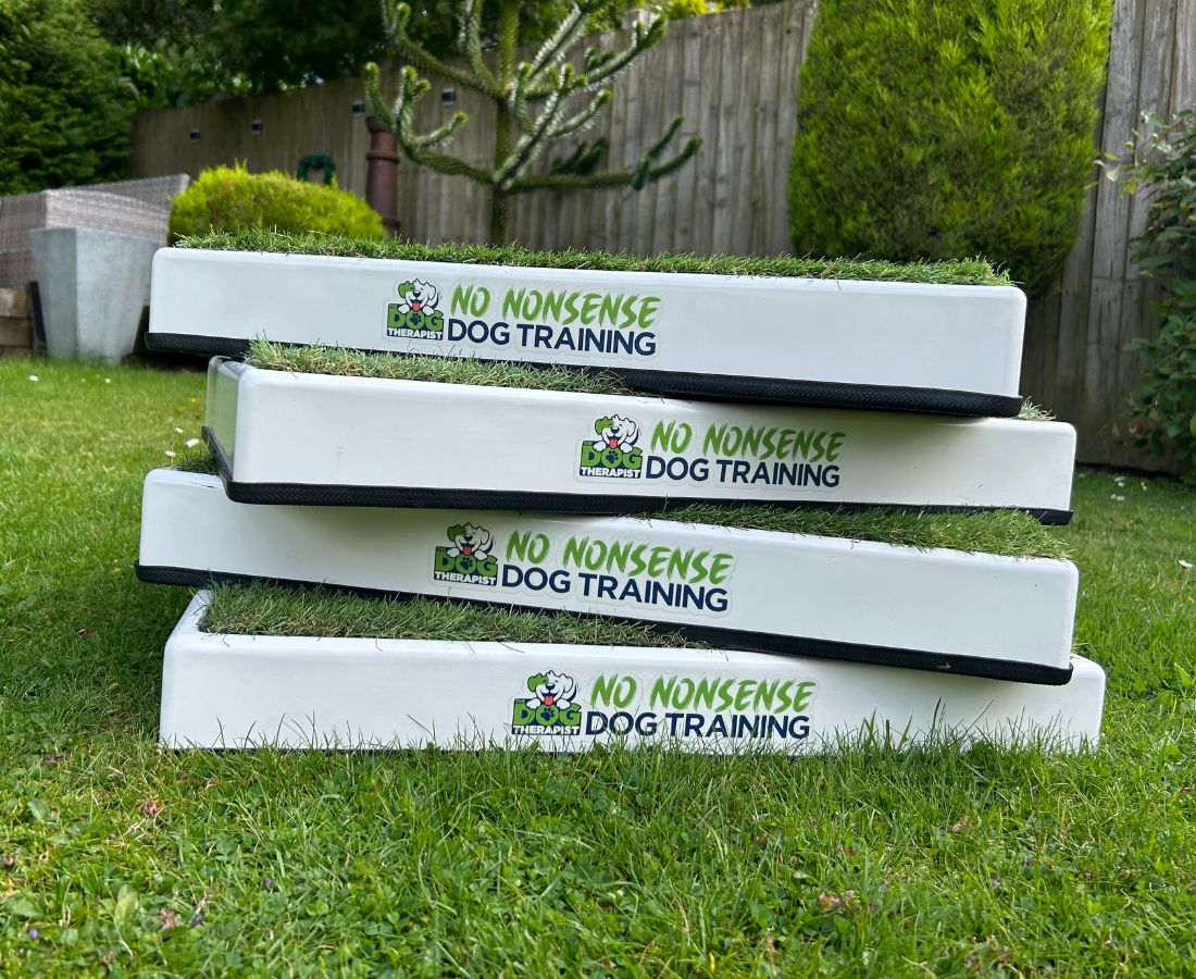 A group of white place boards with artificial grass top | The Dog Therapist